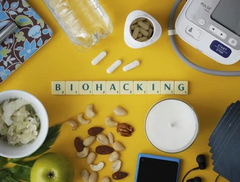 Biohacking flat lay with letters "Biohacking" on yellow background Stock Photos