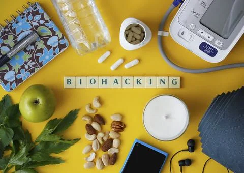 Biohacking flat lay with letters "Biohacking" on yellow background Stock Photos