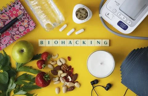 Biohacking flat lay with letters "Biohacking" on yellow background Stock Photos