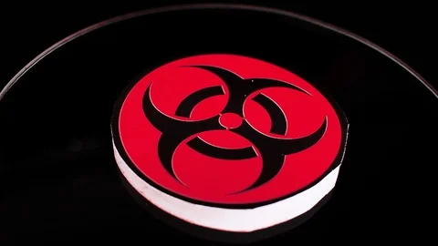 Biohazard sign closeup texture video on rolling rotating looping plate Stock Footage 104327897