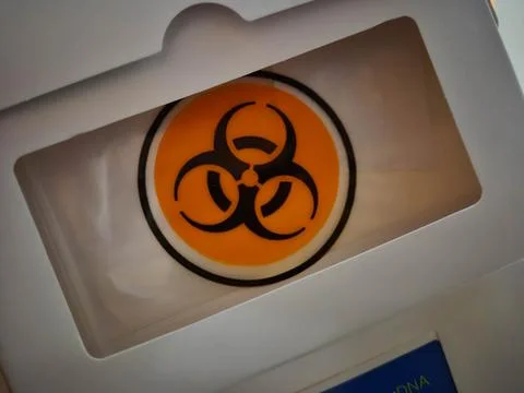 Biohazard symbol on orange background with caution signage Stock Photos