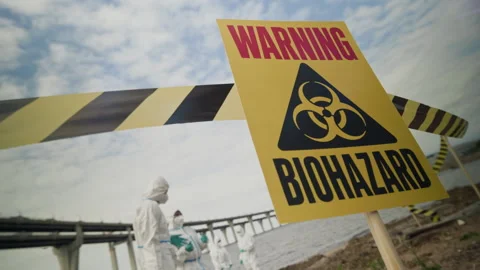 Biohazard Warning Sign with Ecologists Examining Contaminated Area Stock-Footage 344719449