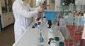 Biohemist tests water at water quality laboratory 2 HD Footage