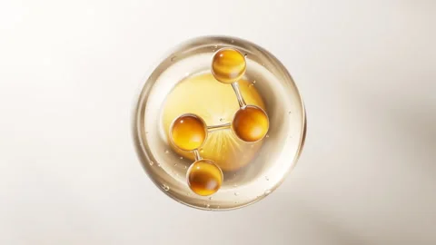 Biological golden molecule with cosmetics background, 3d rendering. Stock Footage 336827406