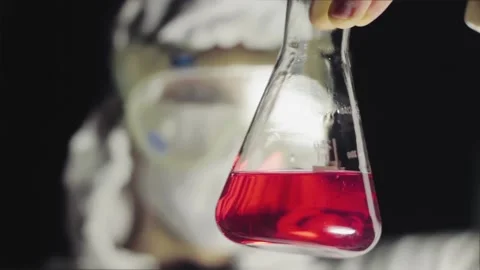 Biological Research - Scientist With Flask Containing Epidemical Material Stock Footage 134345693