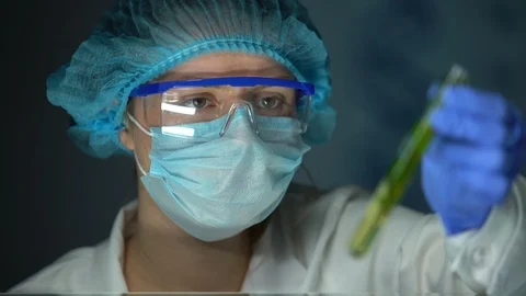 Biologist analyzing green plant sample in tube, biofuel development, environment Stock Footage 104977350