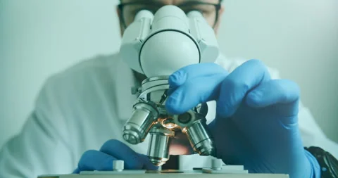 Biologist in Blue Gloves Conducting Microscope Research in Lab Stock Footage 308479327
