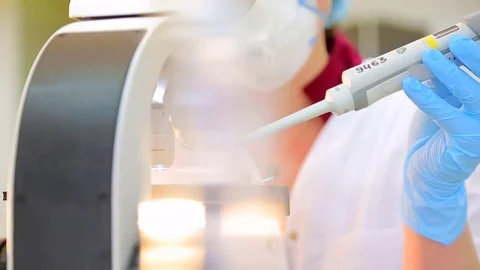 Biologist dropping samples for research microscope Stock Footage 72309074