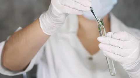 A biologist pulls out a plant sample from a test tube. Stock-Footage 302185873