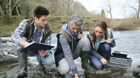 Biologist with students in science testing river water Stock Footage 48604265