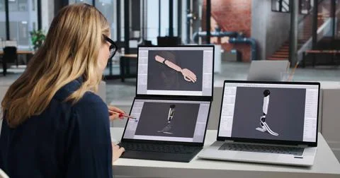 Biomedical Engineer Designs Advanced 3D Prosthetic Leg Using Laptop Software. Stock Photos