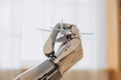 Bionic robot arm holding miniature model of airplane, symbol of travel and Stock Illustration