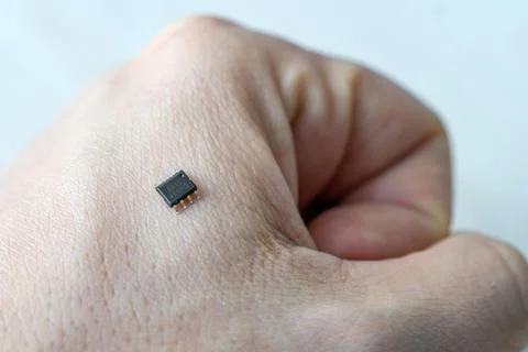 Bionic small microchip on a man's arm - future technology and cybernetics con Stock Photos
