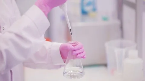 Biotechnologist takes a sample of liquid to test Stock Footage 83585411