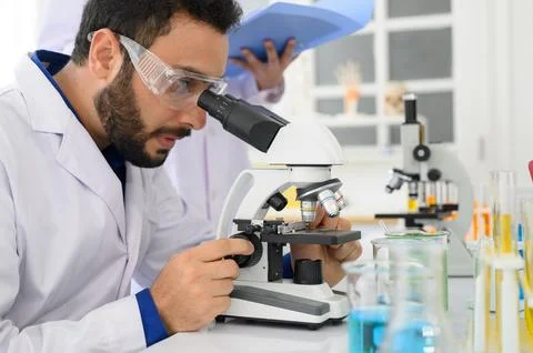 Biotechnology researcher is using a microscope in the lab Stock Photos