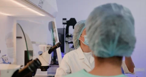 Biotechnology scientist team take test tube to conduct experiments in the Stock Footage 276434858