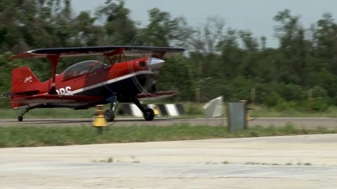 Biplane acrobaster PS-2B taxis steer in parking area. Pilot is in rear cockpit Stock Footage 106370329
