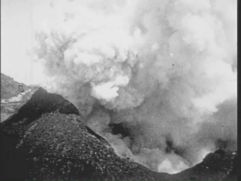 A biplane flying over mountains deploys a parachute and drifts down in the 1920s Vídeos de archivo 75287475