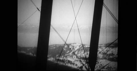 Biplane flying over snowcapped mountain Stock Footage