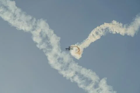 Biplane performing aerobatic loop with smoke trails Stock Photos