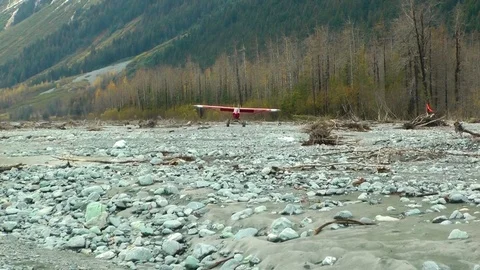 Biplane taking off from forest land Stock Footage 83183877