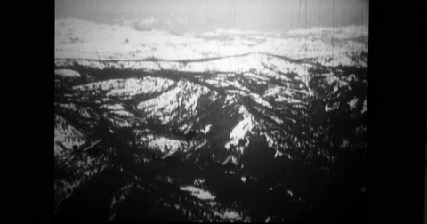 Biplanes from USS Langley flying in formation over snowcapped mountains Stock Footage 43388598