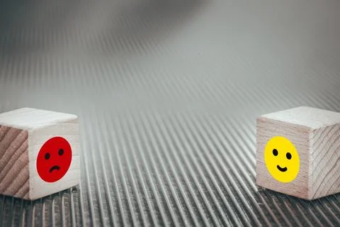 Bipolar disorder, two blocks concept with happy and sad face icons Stock Photos