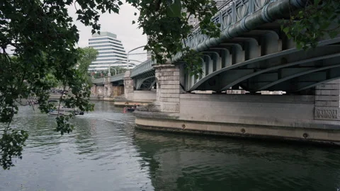 Bir-Hakeim bridge structure over River Seine with motorboat in Paris France Stock Footage 337293945