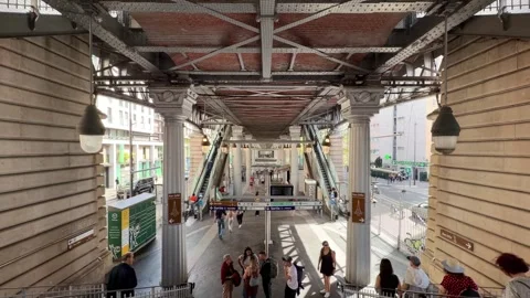 Bir-Hakeim metro station platform with blurred people and Eiffel Tower sign in Stock Footage 334107130