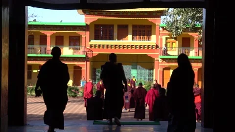 BIR, INDIA - 2020, MAR 15: Monks Silhouetted at Chokling Monastery Courtyard Stock Footage 345632988