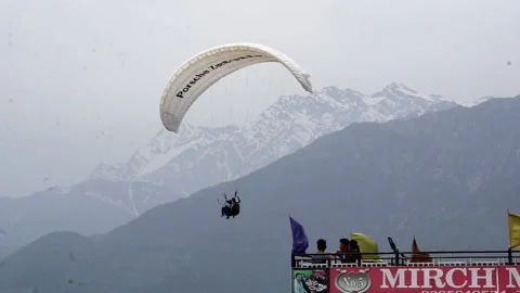 BIR, INDIA - 2020, OCT 18: Tandem Paraglider Soaring Over Dhauladhar Range Stock Footage 208904382