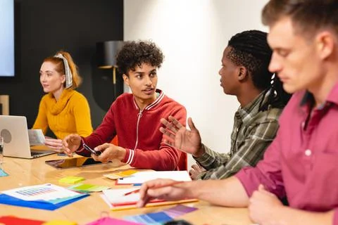 Biracial app developer discussing ideas with african american colleague in Stock Photos