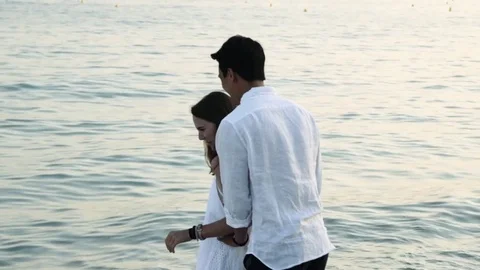 Biracial couple flirting the beach Stock Footage 78365772