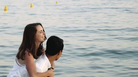 Biracial couple flirting the beach Stock Footage 78365973