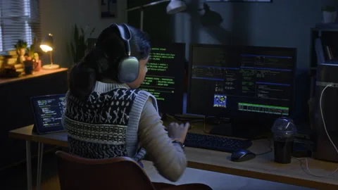 Biracial Female Coder Smiling at Desk with Computer Screens at Night Home Office Stock Footage 328247786