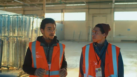 Biracial Male Construction Worker Explaining Work Rules to Trainee Stock Footage 259628200