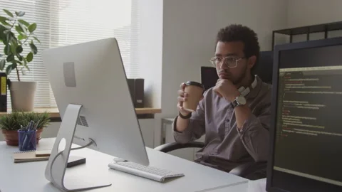 Biracial Programmer Working on Desktop Computer in Office Stock Footage 255781286
