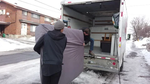 Biracial same sex couple loading a moving van together Video stock 147053432
