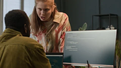 Biracial Startup Workers Talking about Programming Code on Digital Gadgets Stock Footage 302889235