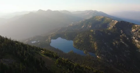 Birch Lake Below Rugged Mountain Ridge Jewel Basin Montana Hazy Day Pullback Stock-Footage 332374553
