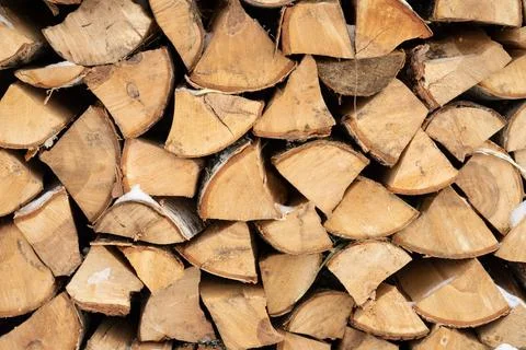 Birch logs stacked in a raspberry, winter, background Stock Photos