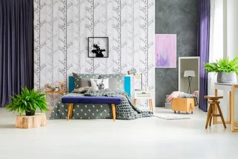 Birch tree wallpaper above bed Stock Photos