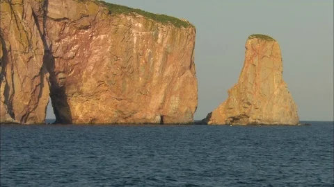 A bird dives in front of Rocher Perce Stock Footage 82148232