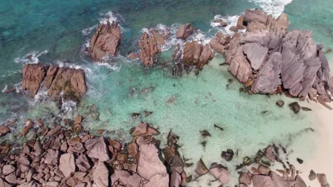 Bird eye drone view of granites stones near shoreline, clear turquoise water, 스톡 동영상 333937446