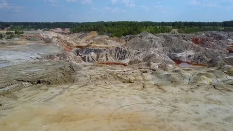 Bird eye flight over clay pit by forest under blue sky Vidéo 94017023