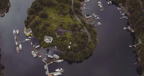Bird eye flight over island in fjord with yachts houses road Stock Footage 101321565