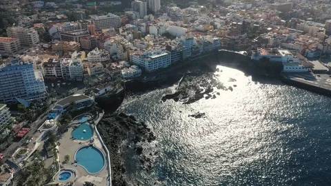 Bird eye flight sunlight glares on ocean water near island Stock Footage 101960975