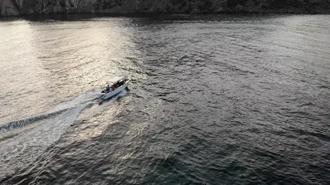 Bird eye flight white speed boat sails on waving blue sea Video stock 103180938