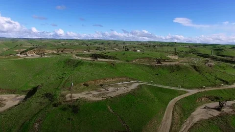 Bird eye shot of pumpjacks in a middle of beautiful green field Stock Footage 79426740
