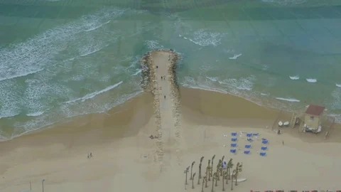 Bird eye view of the beach and sea with rocky pier Stock Footage 81354715